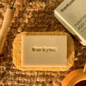 Handmade natural soap on a coir mat with eco-friendly packaging, perfect for sustainable skincare.